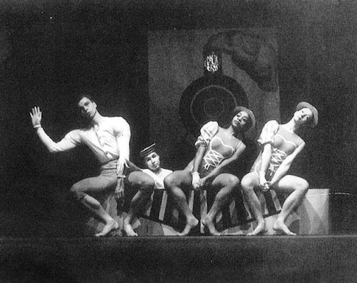 A black and white photo of dancers on a stage.